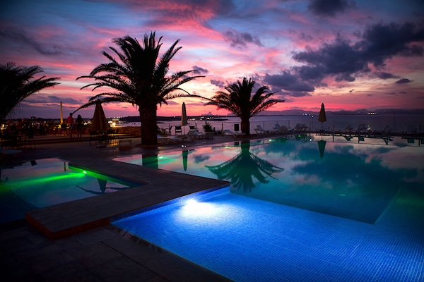 Seasonal outdoor pool, open 11:00 AM to 7:00 PM, pool umbrellas