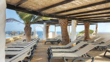 Seasonal outdoor pool, open 11:00 AM to 7:00 PM, pool umbrellas