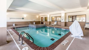 An indoor swimming pool with clear lane markings, a changing room, and a covered seating area. - Quality Inn & Suites Guymon East (Guymon)