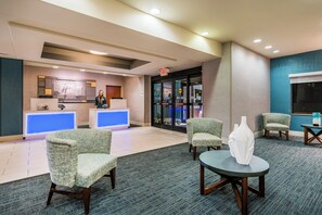 A hotel reception area with a desk, chairs, and a seating area. - Holiday Inn Express Hotel & Suites Rocky Mount by IHG (Rocky Mount)