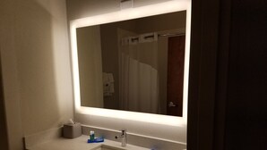 A bathroom with a large mirror, a sink, and a towel rack. - Holiday Inn Express & Suites Rio Grand by IHG (Rio Grande City)