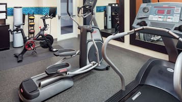 A gym with treadmills, ellipticals, and weight machines.