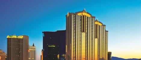A high-rise hotel with a prominent central tower, multiple smaller buildings, and a parking structure.
