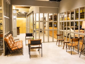 Een modern interieur met zithoekjes en grote ramen.