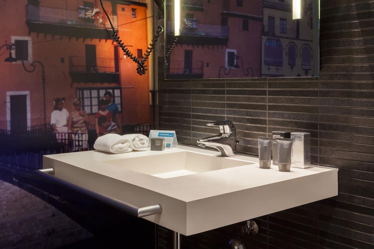 designer toiletries, hair dryer, bidet, towels