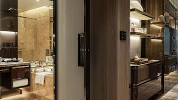 A modern bathroom with a marble floor, a large mirror, and a wooden vanity.