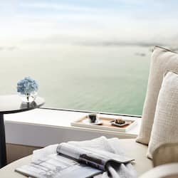 Relax in a peaceful haven with a stunning ocean view, featuring a comfortable seating area and beautiful decor.