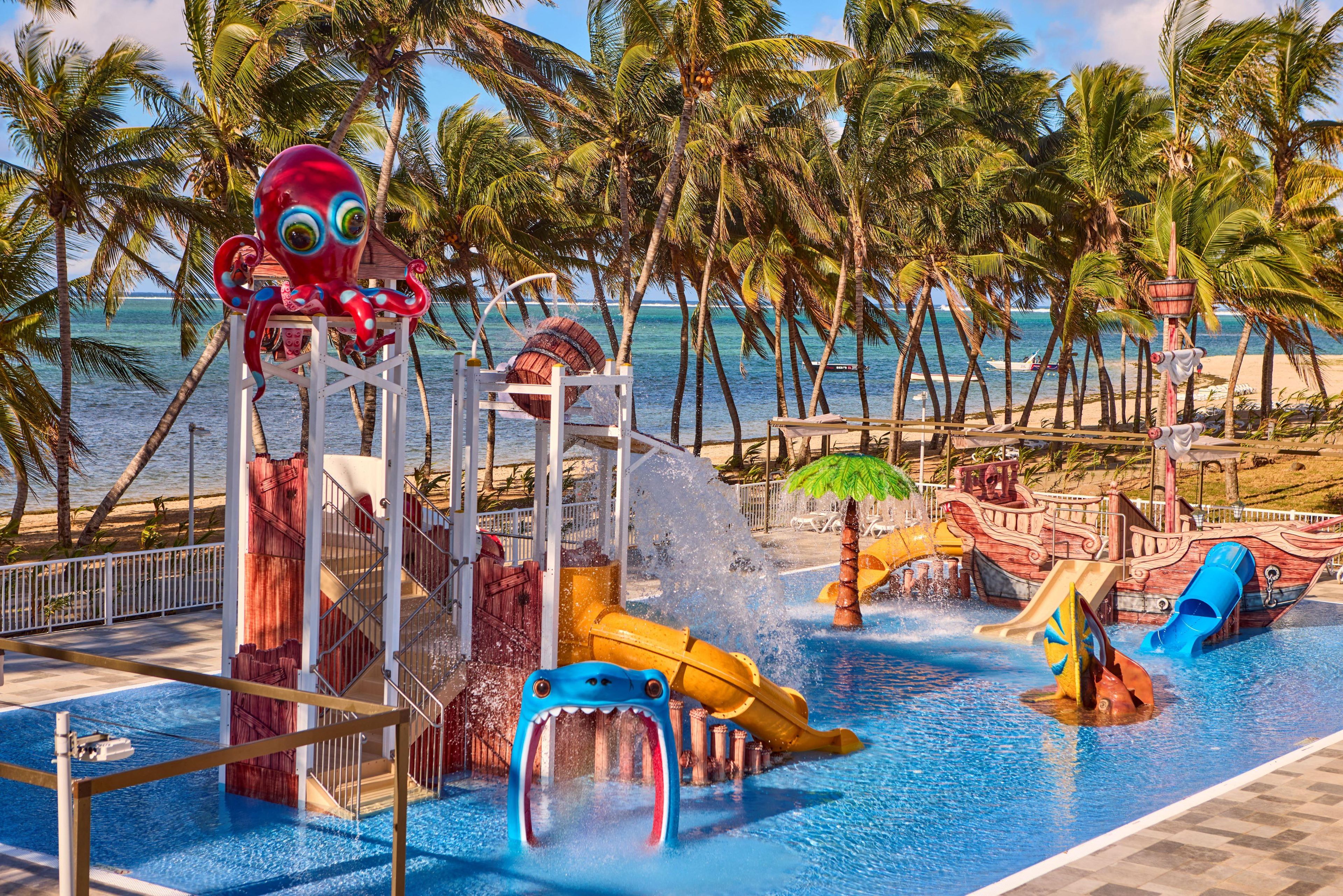 A water park with slides and a large octopus statue.