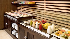 A buffet with various food items and beverages, including fruits, vegetables, and different types of drinks. - NH Valladolid Bálago (Valladolid)