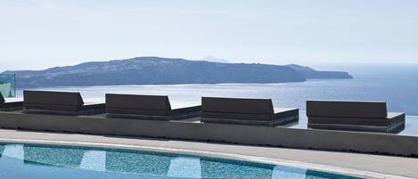 Outdoor pool, open 8 AM to 8 PM, pool umbrellas