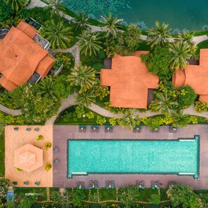 An aerial view of a resort with a swimming pool, palm trees, and bungalow-style accommodations. - Angkor Palace Resort & Spa (Siem Reap)