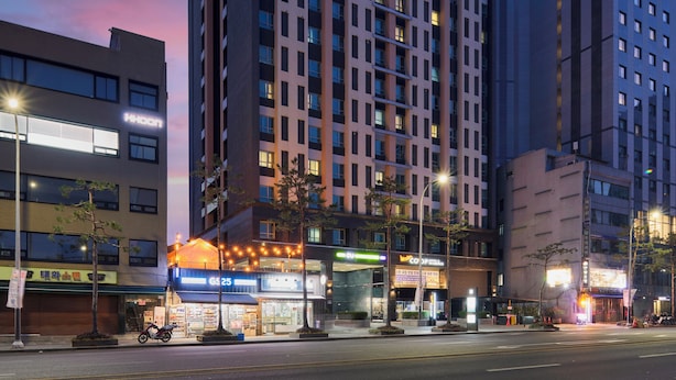 A high-rise hotel with multiple floors, large windows, and a prominent entrance. - Western Coop Residence Dongdaemun (Seoul)
