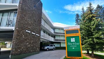 A multi-story building with a stone facade and balconies. A sign indicates 'No Vacancy' at the entrance.