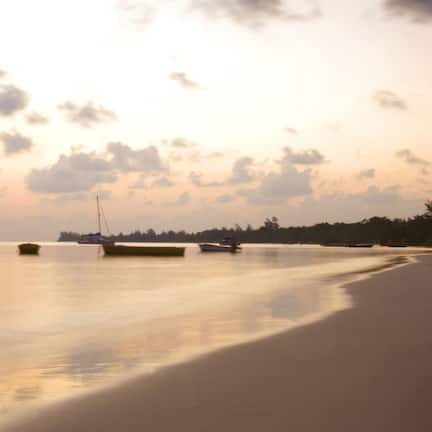 On the beach, white sand, beach umbrellas, beach towels