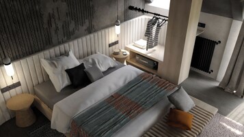 Una habitación de hotel moderna con una cama grande, una mesita de noche con lámpara, y vistas a la ciudad a través de una ventana.