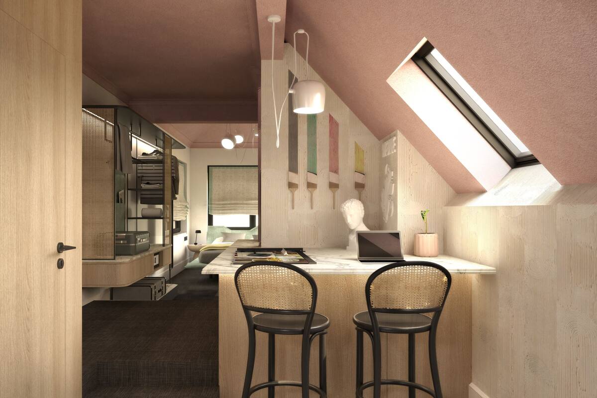 Una cocina moderna con comedor, que incluye una isla con taburetes, horno empotrado y ventana con vistas.