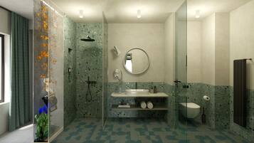 A modern bathroom with a shower, sink, and toilet.