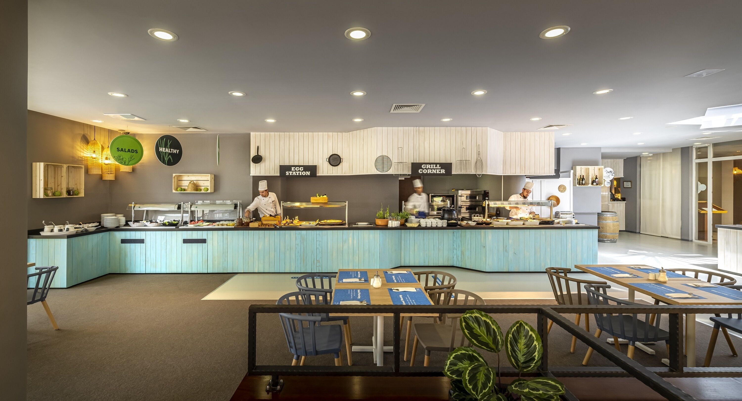 A modern restaurant with a central counter and seating area.