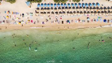 On the beach, sun loungers, beach umbrellas