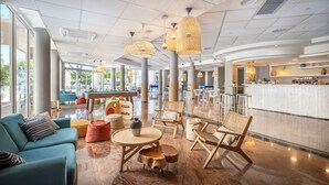 A spacious lobby with a seating area featuring sofas, chairs, and a coffee table. - Sunny Baška Hotel by Valamar, ex Corinthia (Baska)