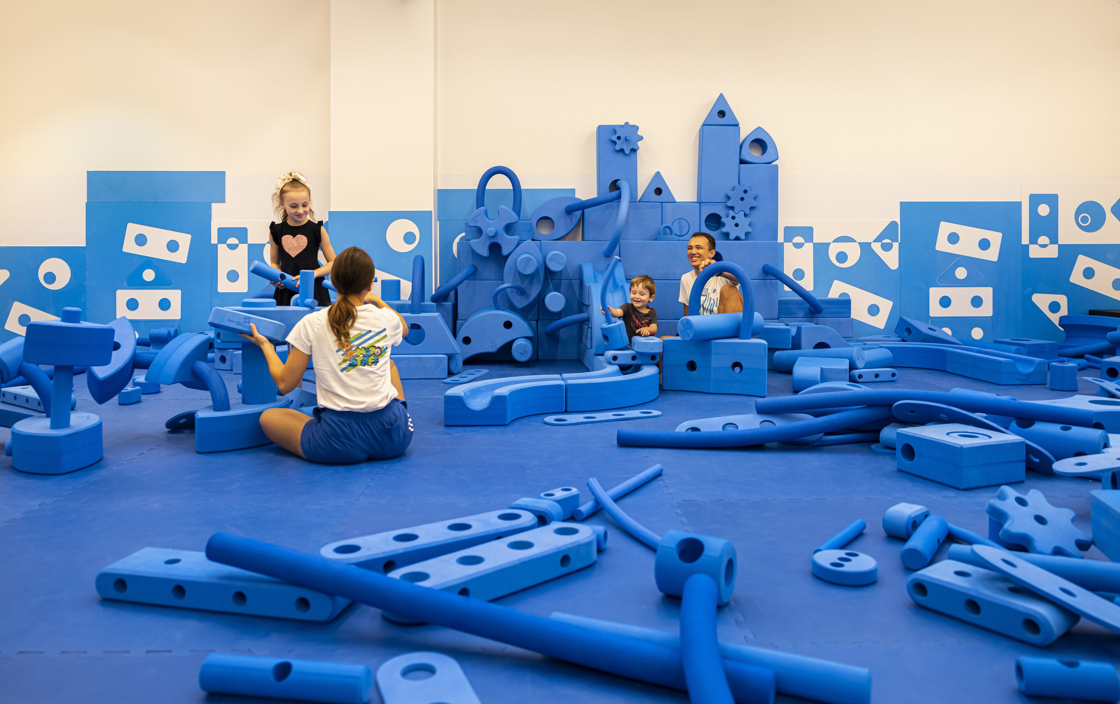 A play area with various blue play structures and equipment.