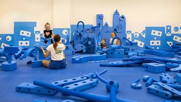A play area with various blue play structures and equipment.