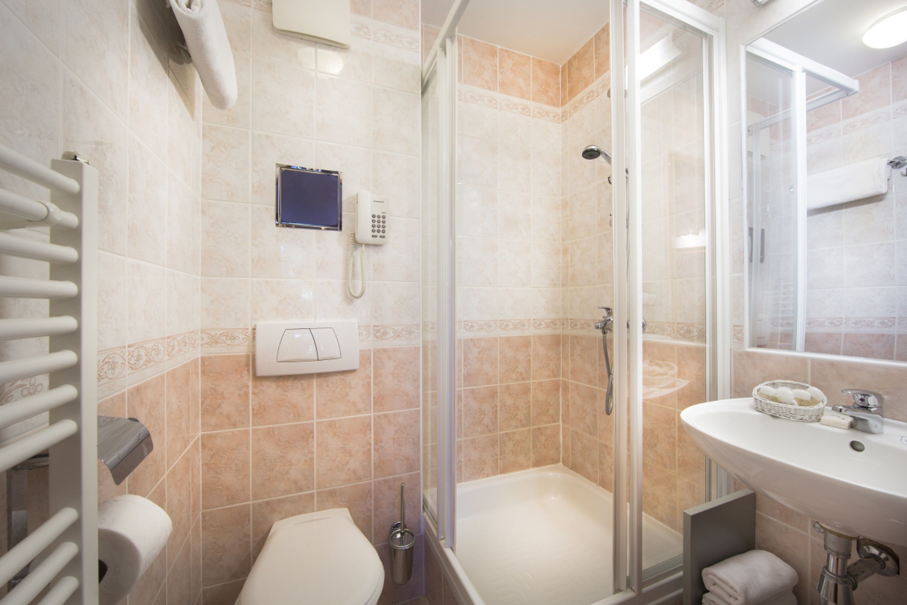 A modern bathroom with a shower, toilet, and sink.