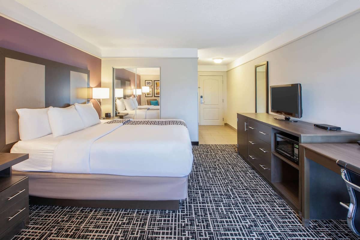 Premium bedding, desk, laptop workspace, blackout drapes