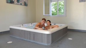 A room with a hot tub, a window, and a painting on the wall. - Domaine de la Vingeanne (Villegusien-le-Lac)