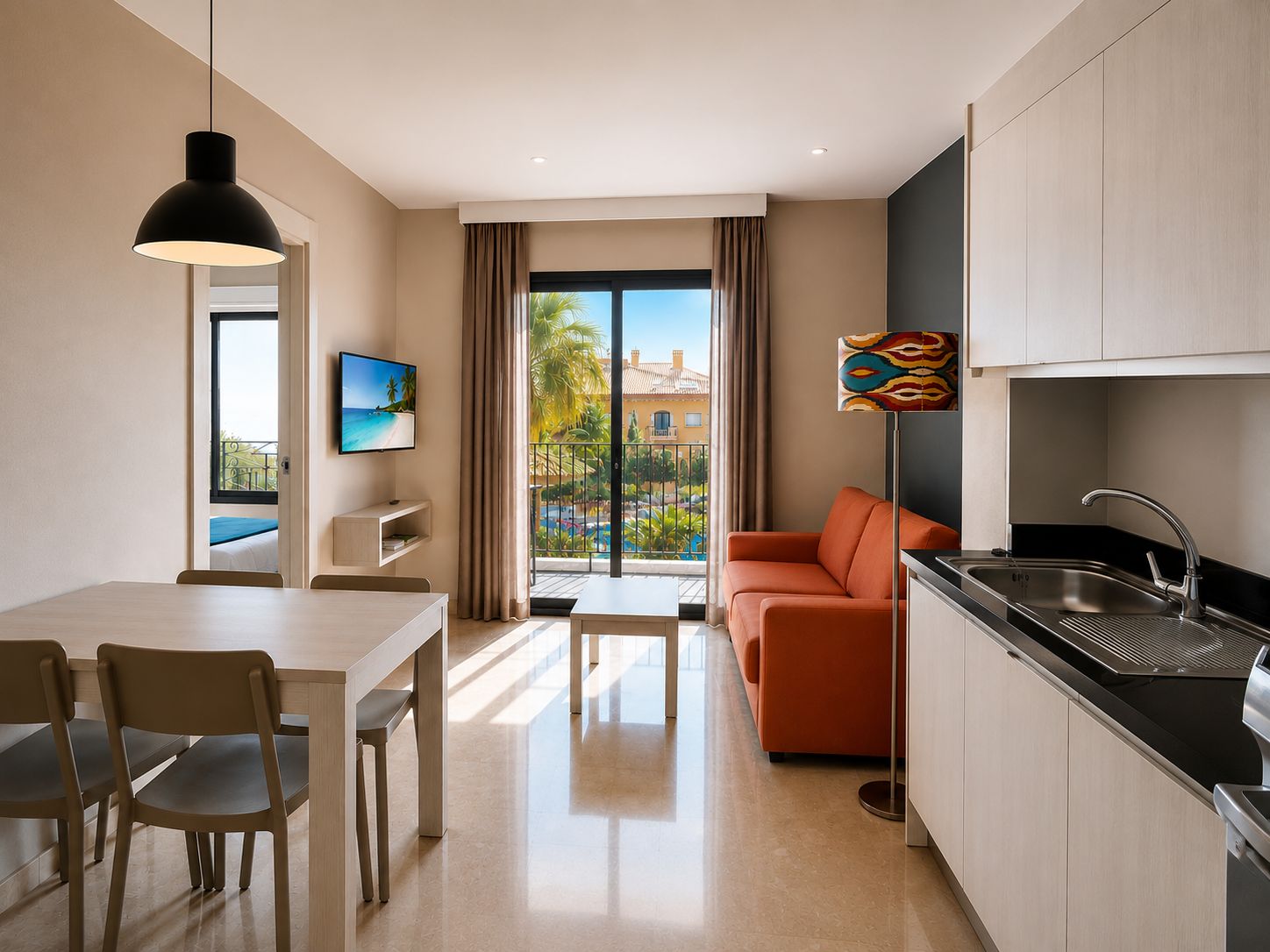 A modern kitchen with a dining area, a sofa, and a TV.