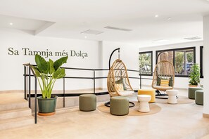 A modern interior with a staircase, hanging chairs, and a potted plant. - Tangerine by Honne Hotels - Adults Only ¨New Opennig¨ (Calvia)
