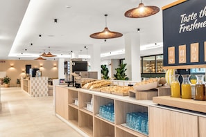 A modern cafe interior with a counter displaying pastries and beverages, a wall with a menu, and a clean, organized layout. - Tangerine by Honne Hotels - Adults Only ¨New Opennig¨ (Calvia)