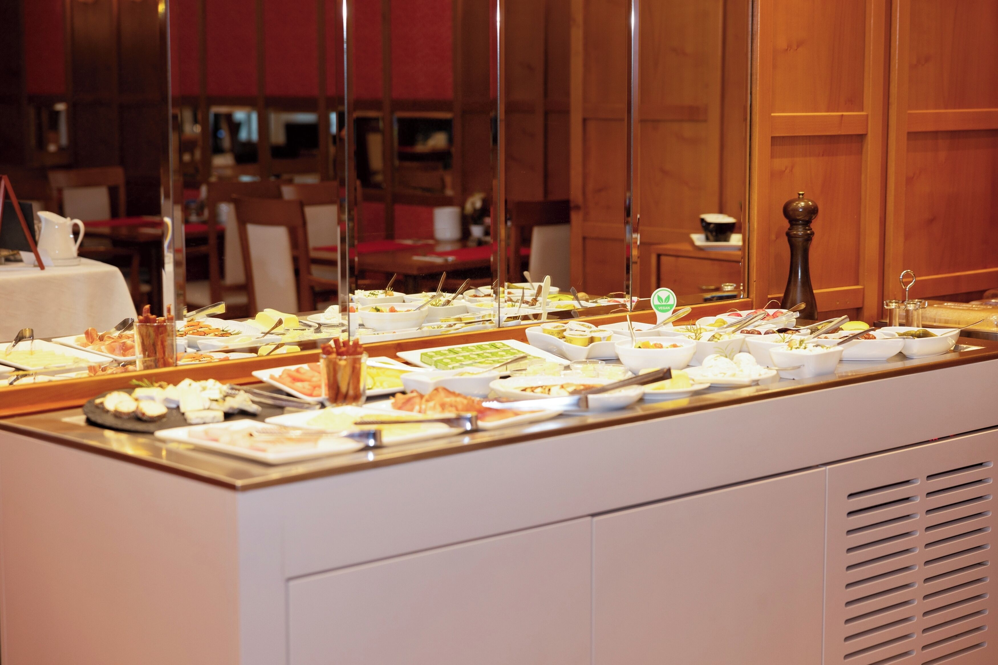 A buffet with various dishes and utensils.