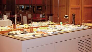 A buffet with various dishes and utensils.