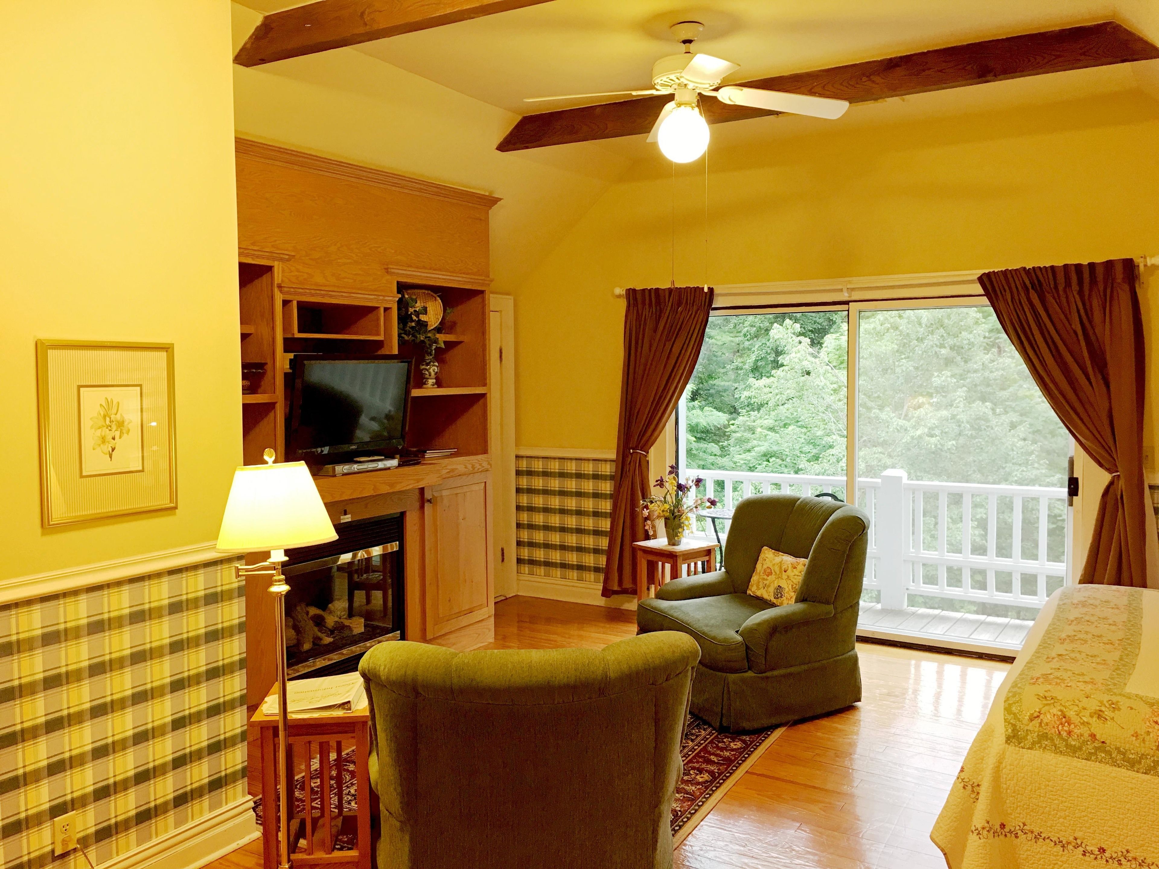 A cozy living room with a fireplace, television, and comfortable seating.