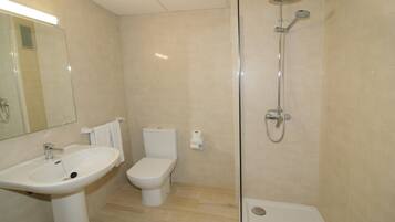 A bathroom with a sink, toilet, and shower.