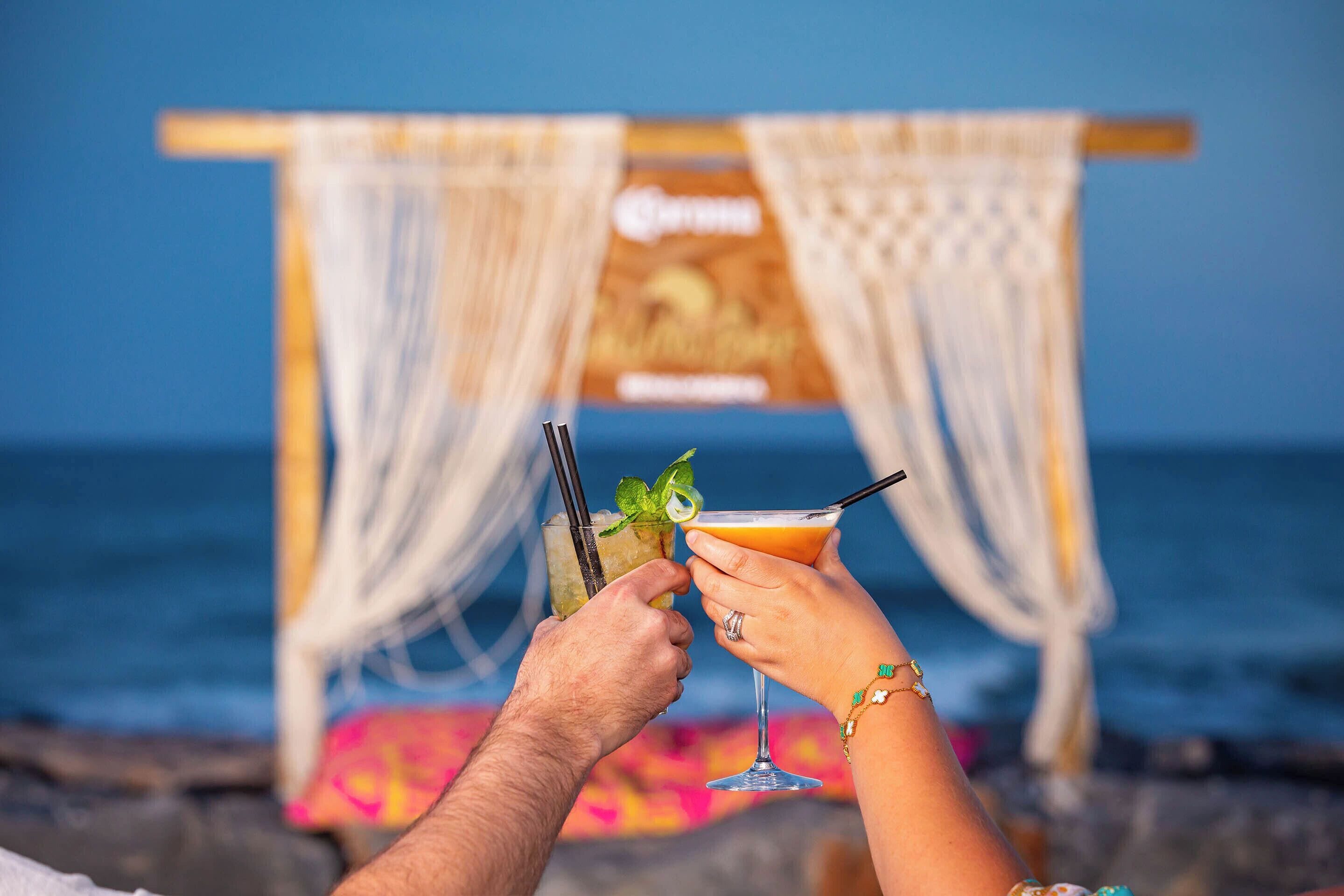 A beach setting with a tiki bar and a sign that reads "Coconut Paradise."