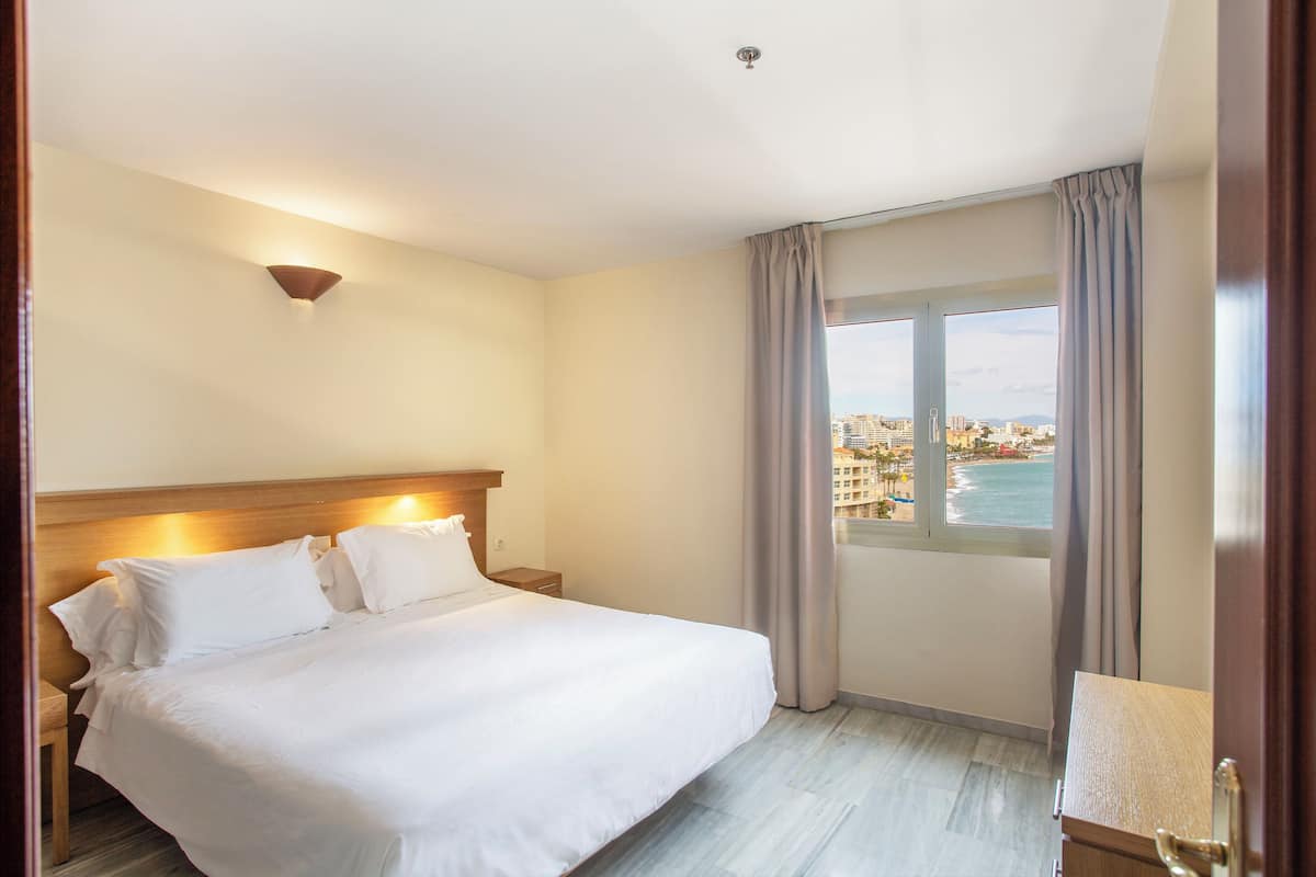 Family Apartment, 1 Bedroom, Terrace, Sea View | 1 bedroom, in-room safe, blackout drapes, iron/ironing board
