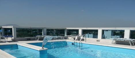 Seasonal outdoor pool, a rooftop pool, sun loungers