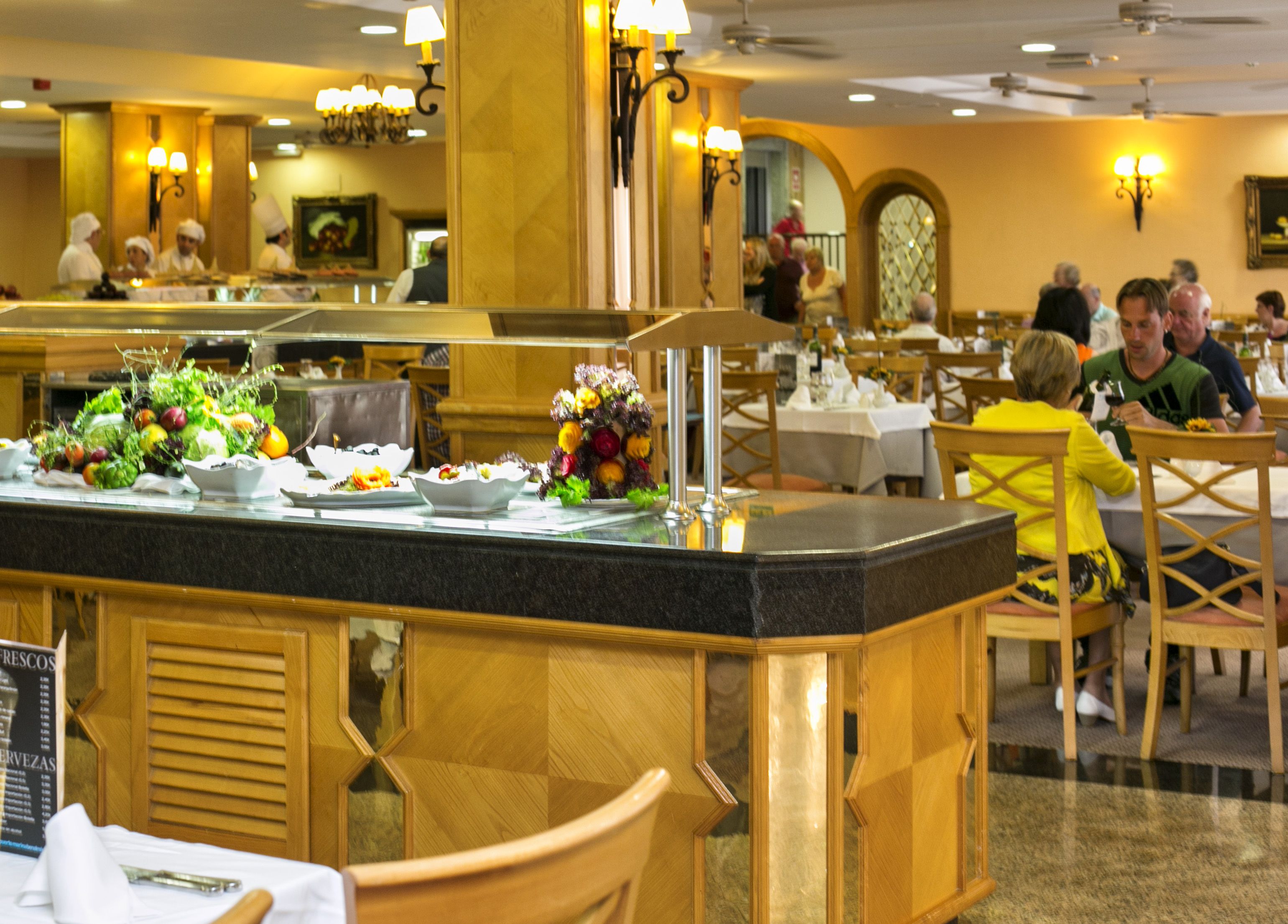 A buffet area with various dishes and a mirror reflecting the room.