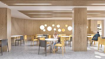 Una cafetería moderna con detalles de madera, mesas y sillas redondas.