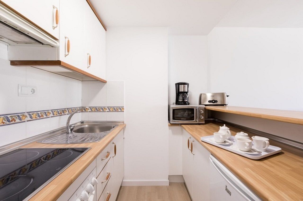 Fridge, microwave, coffee/tea maker, cookware/dishes/utensils