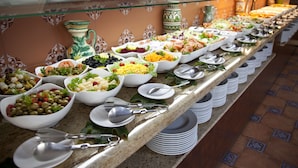 A buffet with various food items and utensils. - Hotel Tarik (Torremolinos)
