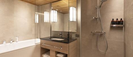 A modern bathroom with a glass-enclosed shower, a wooden ceiling, and a large bathtub.
