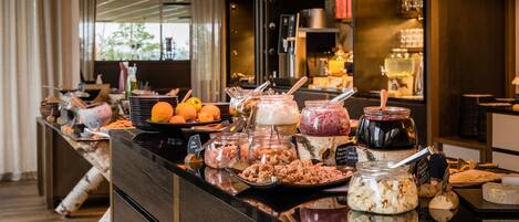 A buffet with various food items and condiments.