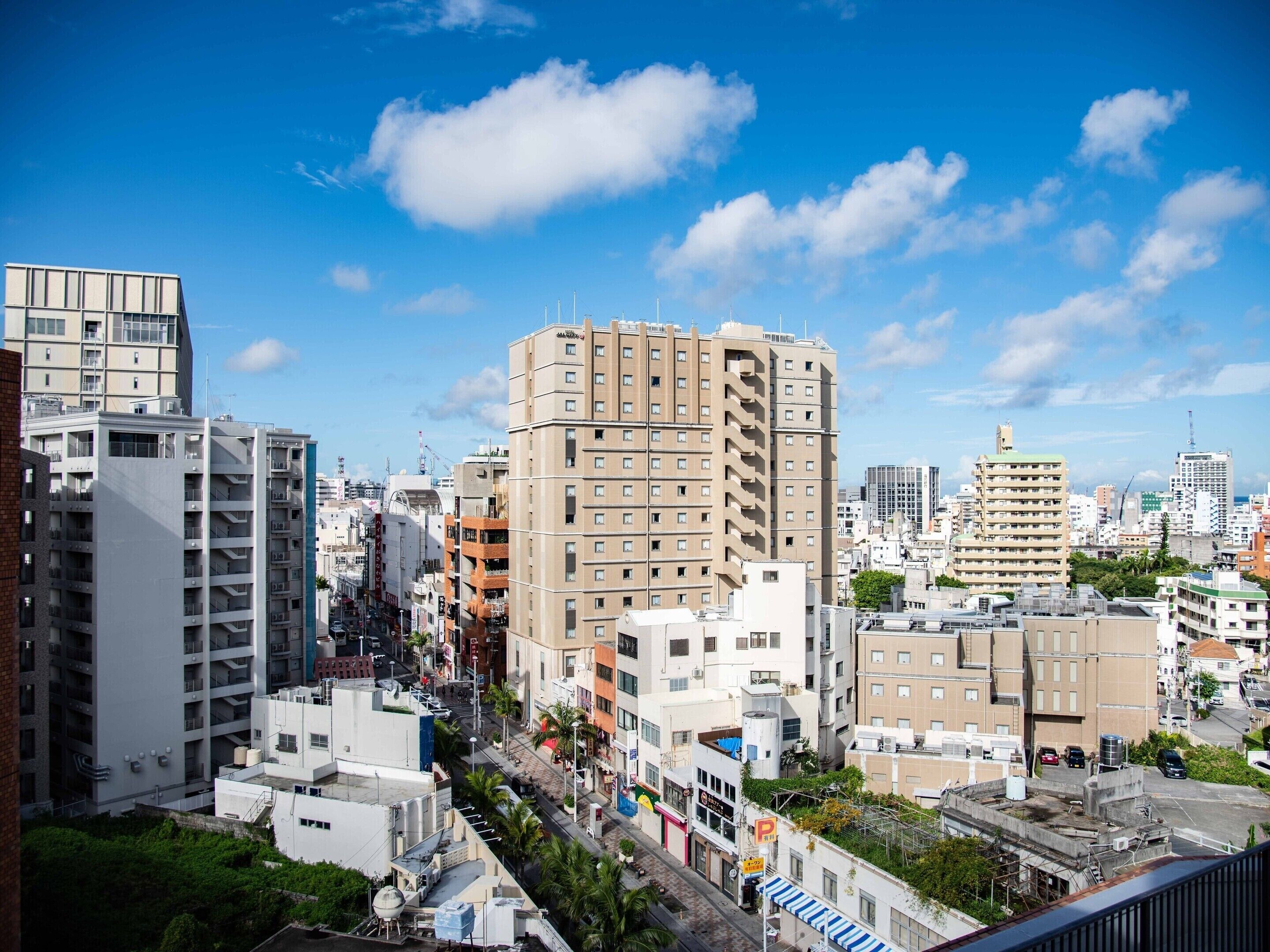 A cityscape with high-rise buildings, a clear sky, and a mix of commercial and residential structures.