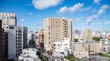 A cityscape with high-rise buildings, a clear sky, and a mix of commercial and residential structures.