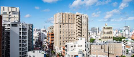 A cityscape with high-rise buildings, a clear sky, and a mix of commercial and residential structures.