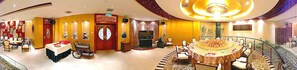 A hotel lobby with a round dining table, a television, and a wheelchair-accessible area. - Media Center Hotel (Beijing)