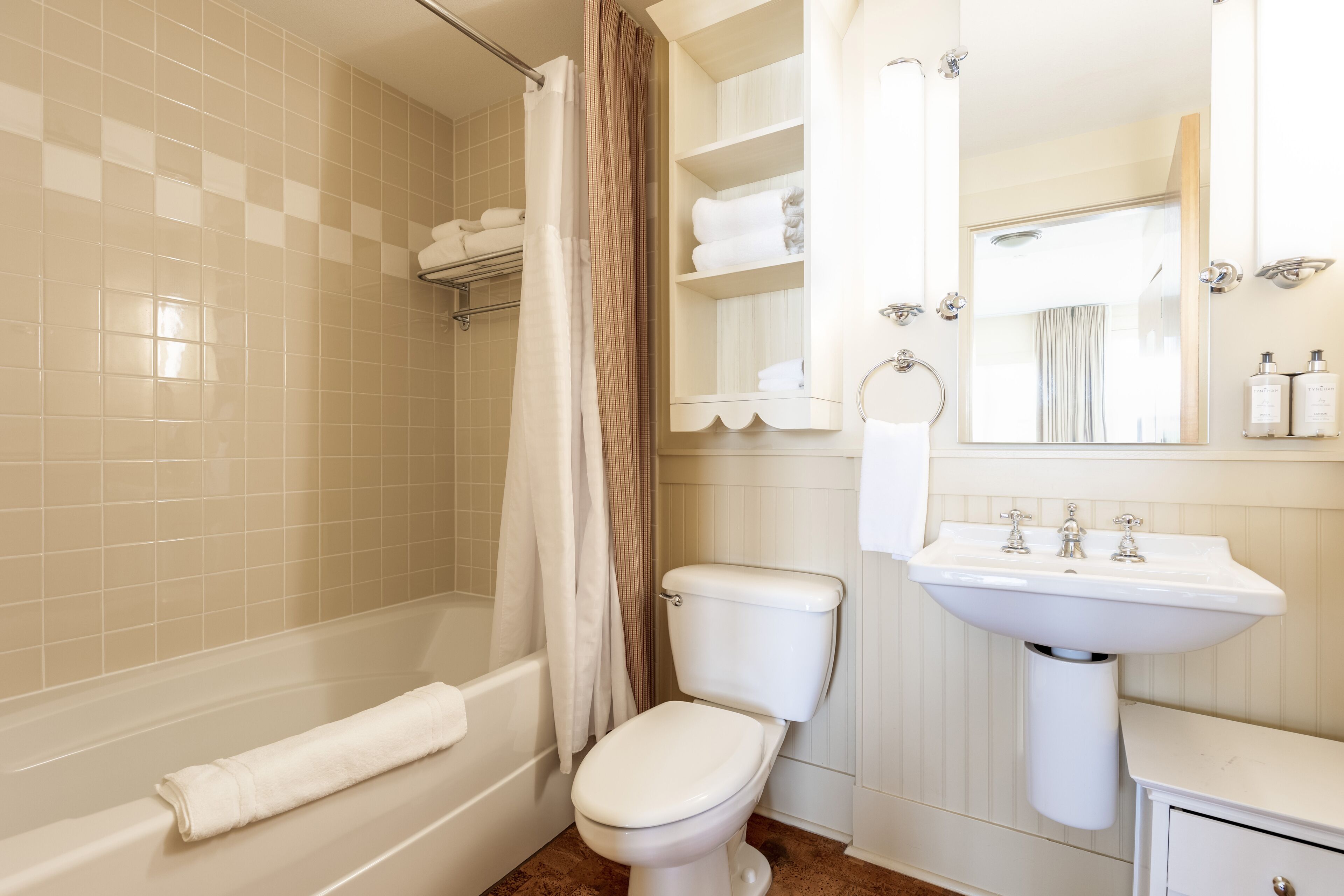 A bathroom with a bathtub, toilet, and sink.